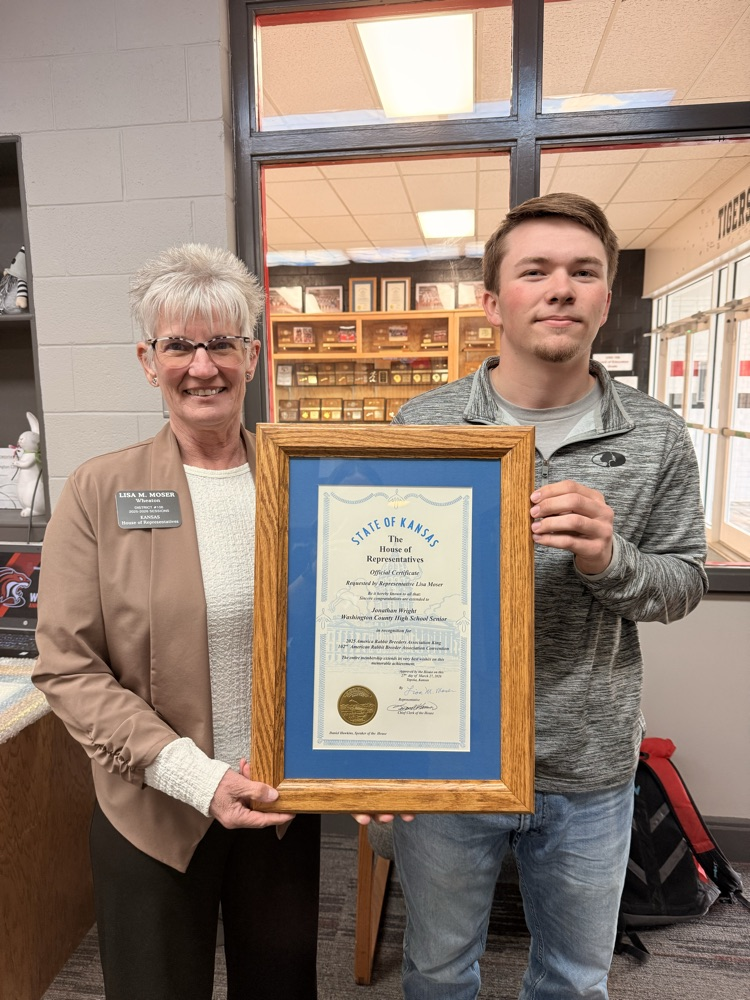 Representative Moser presenting WCHS Senior Jonathan Wright with a certificate of congratulations for his accomplishments at the national level with the American Rabbit Breeder’s Association
