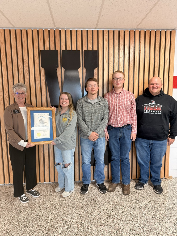 Representative Moser presenting Mr. Kern and members of the FFA National Champion Agronomy Team with a certificate of congratulations