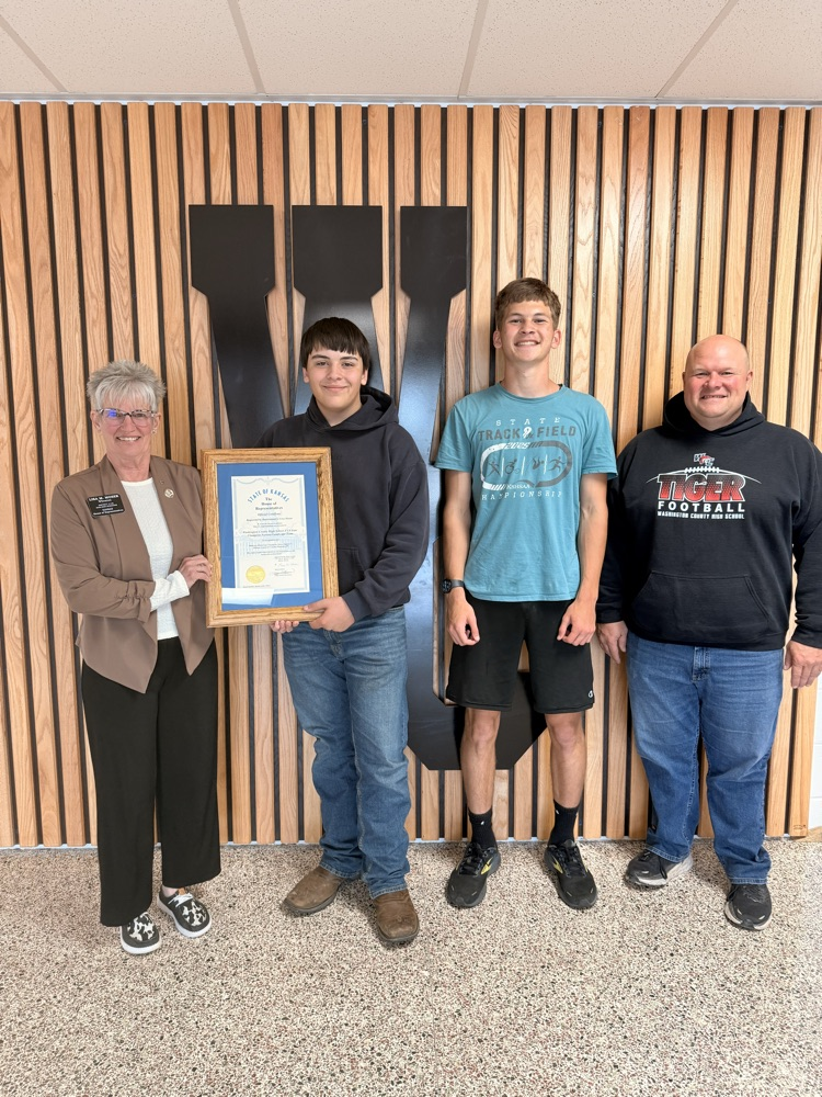 Representative Moser presenting Mr. Kern and members of the FFA State Champion Nursery and Landscape Team with a certificate of congratulations
