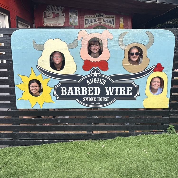 All 5 girls at a bbq restaurant posing with a fun animal sign