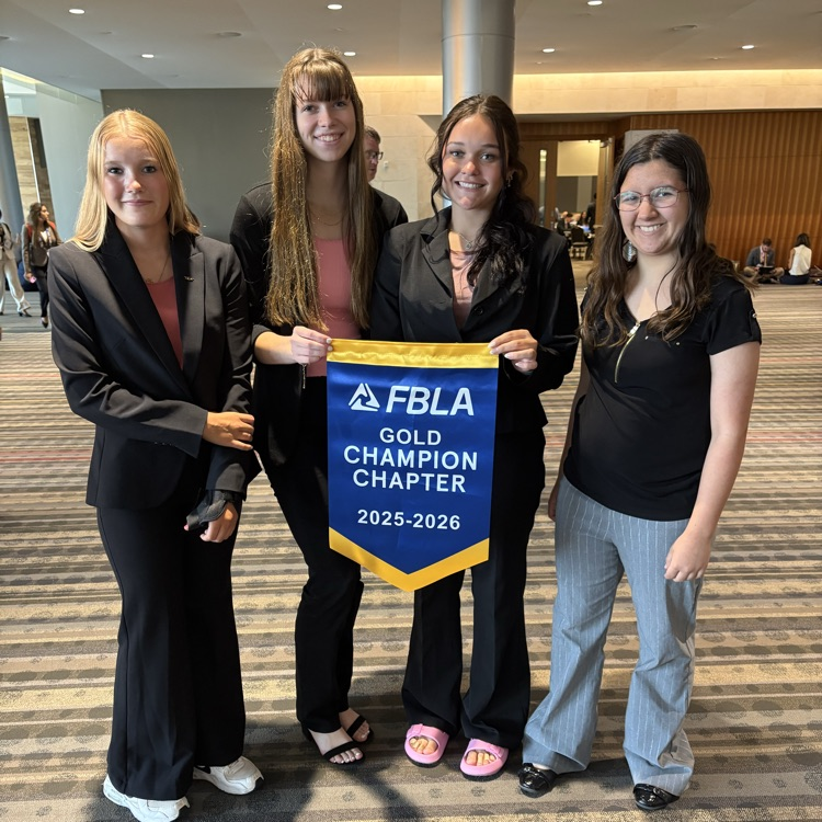 4 of the girls pictured with our gold champion chapter banner