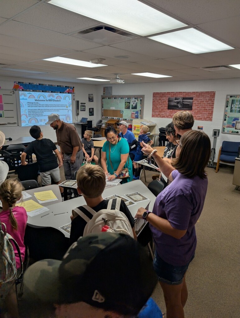 Back to school open house with parents, teachers, and students visiting classrooms.