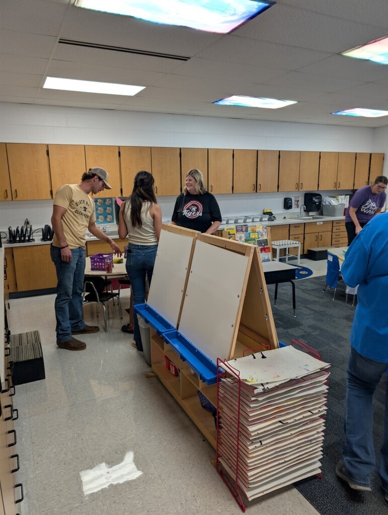 Back to school open house with parents, teachers, and students visiting classrooms.
