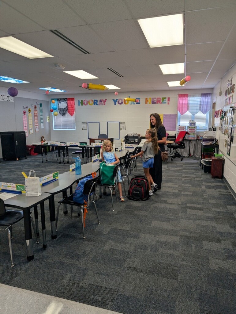 Back to school open house with parents, teachers, and students visiting classrooms.