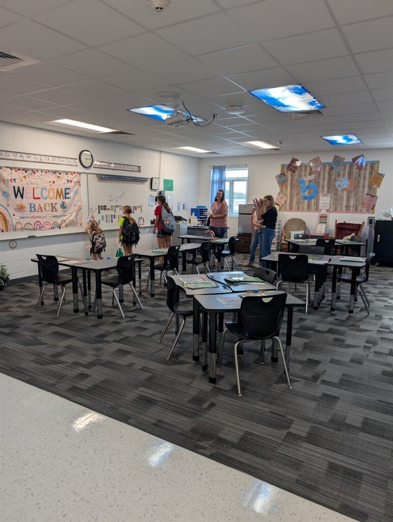 Back to school open house with parents, teachers, and students visiting classrooms.