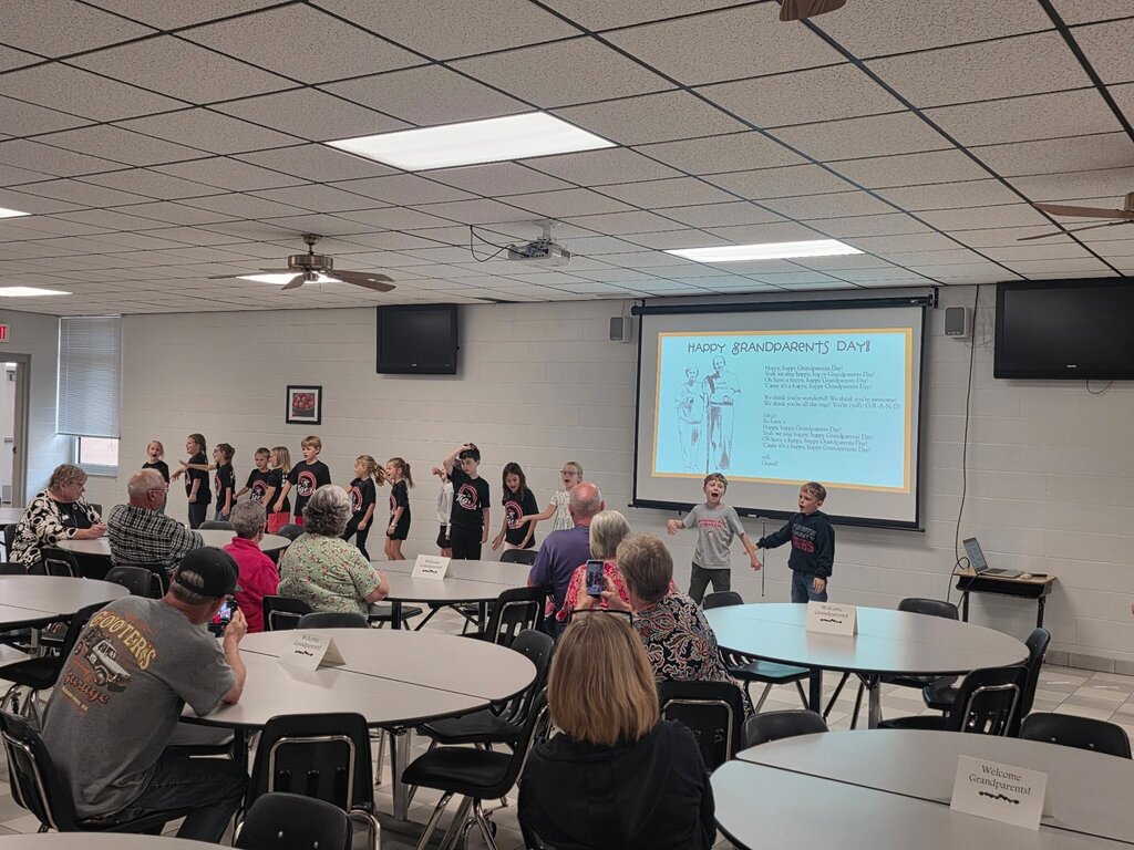 students performing for grandparents
