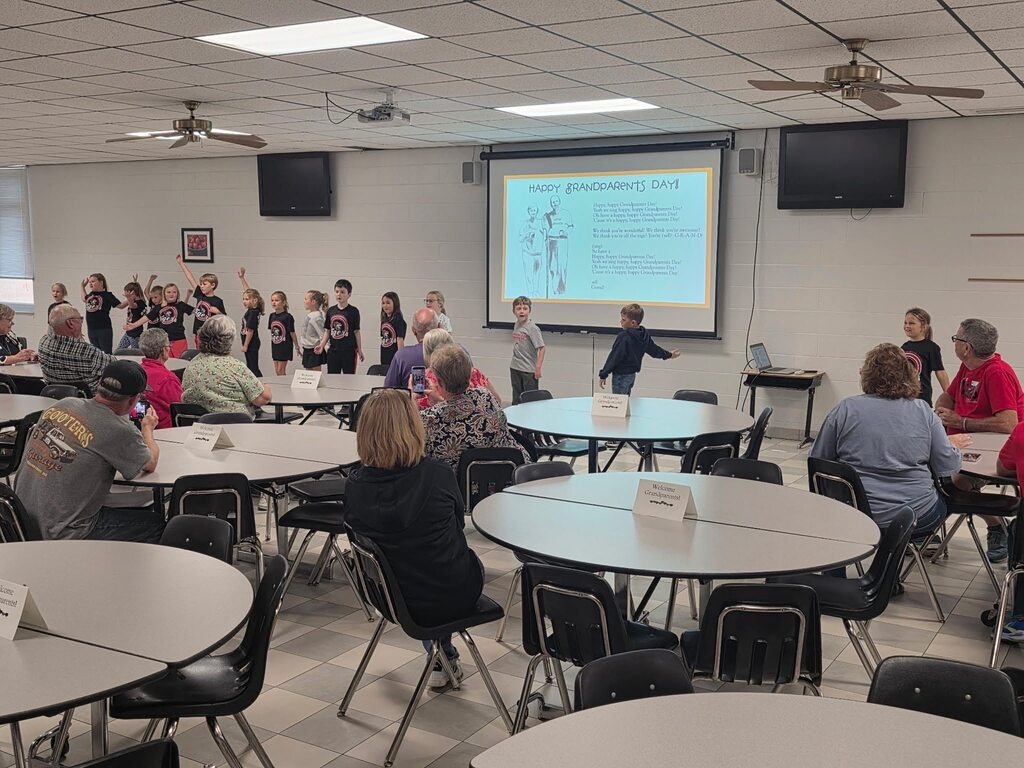 students performing for grandparents