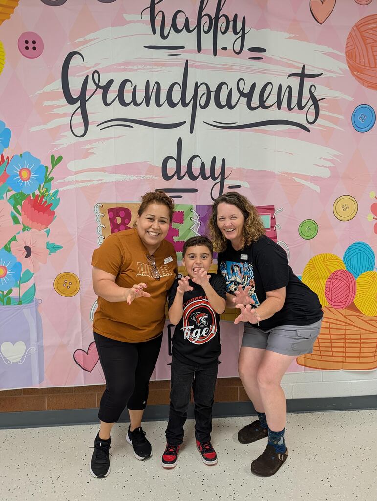 students posing with grandparents