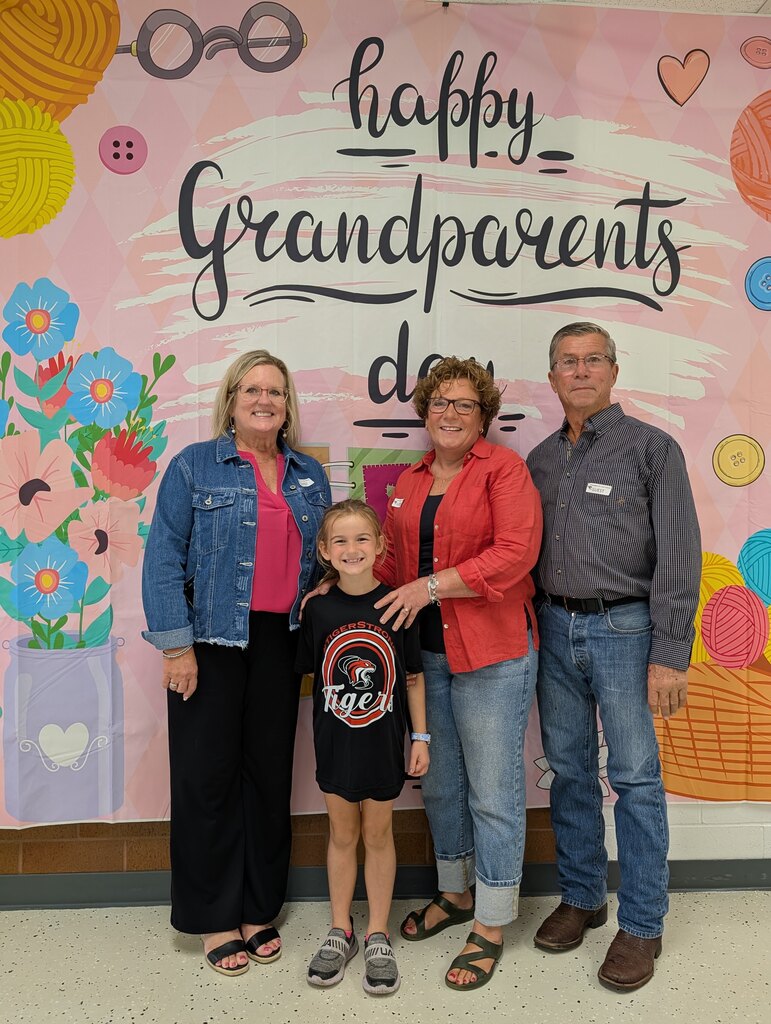 students posing with grandparents