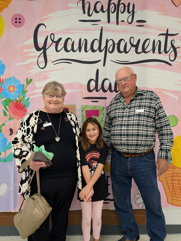 students posing with grandparents