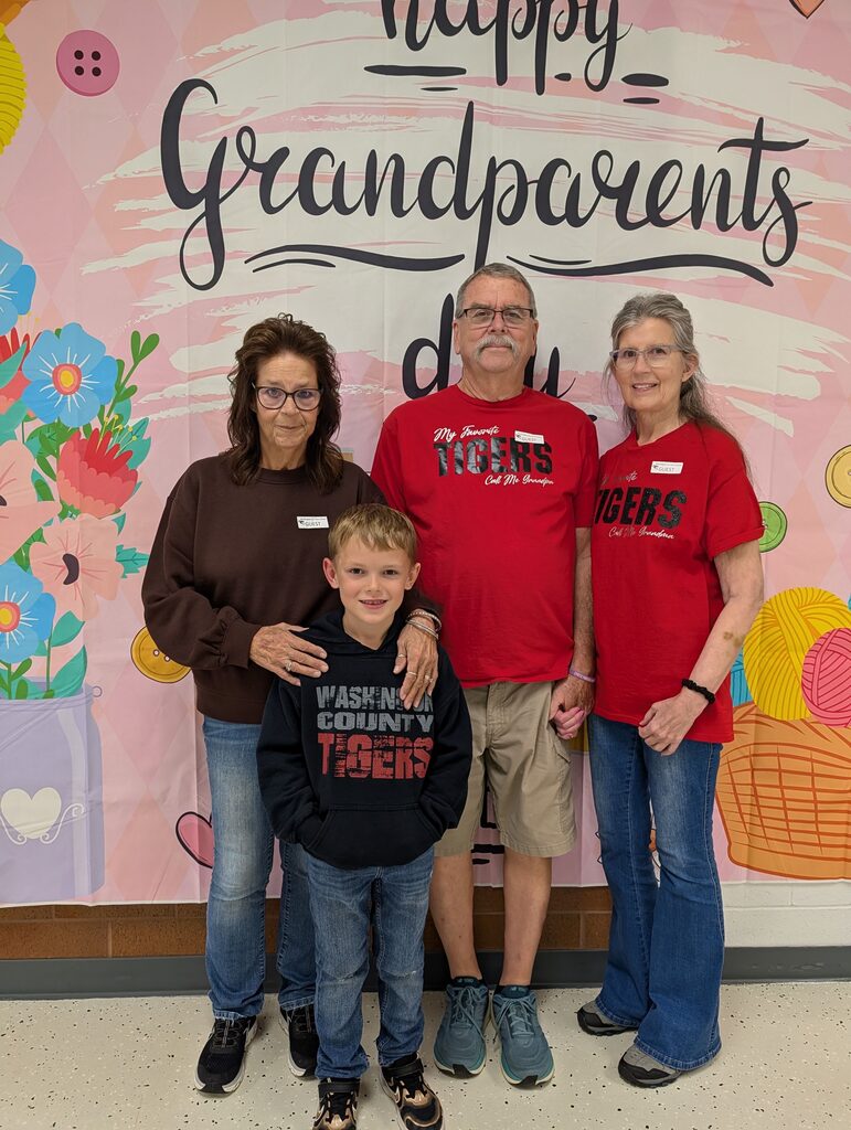 students posing with grandparents