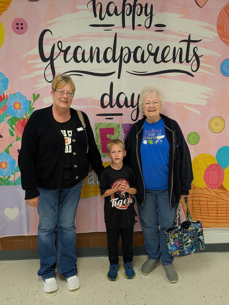 students posing with grandparents