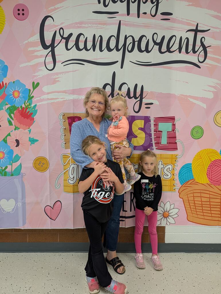 students posing with grandparents