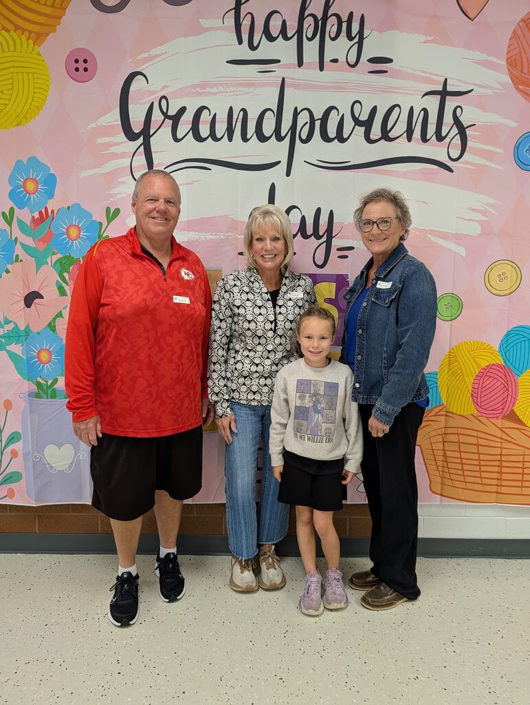 students posing with grandparents