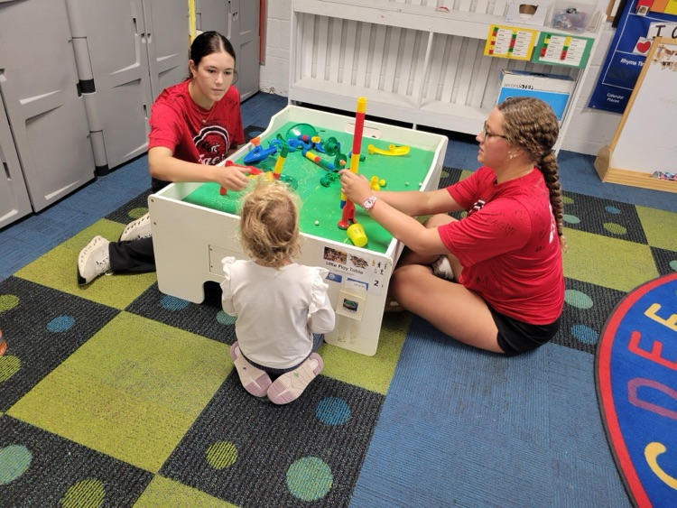 seniors Anna Goeckel and Kelly Annunziato playing at the Preschool