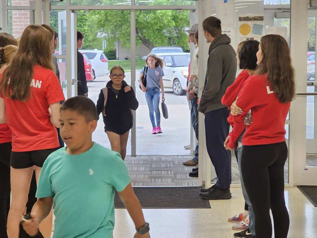 track and golf athletes greeting and playing with elementary students