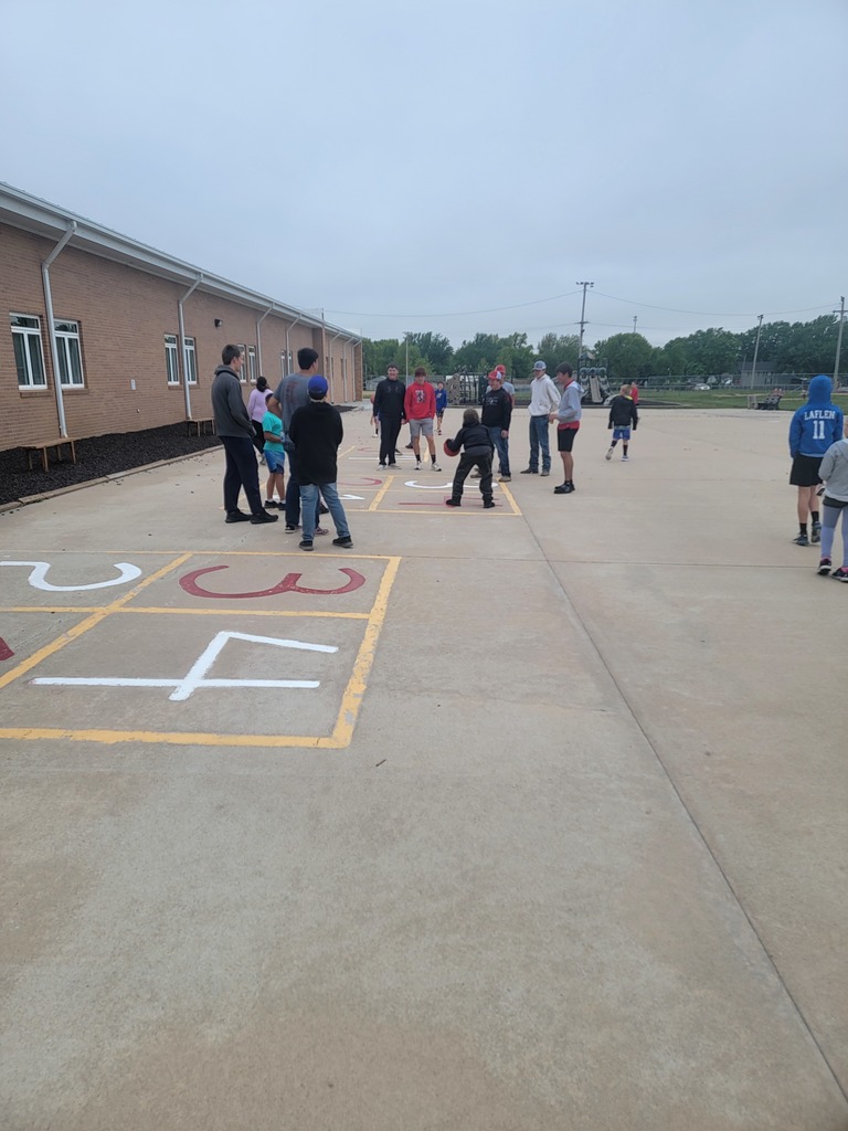 track and golf athletes greeting and playing with elementary students