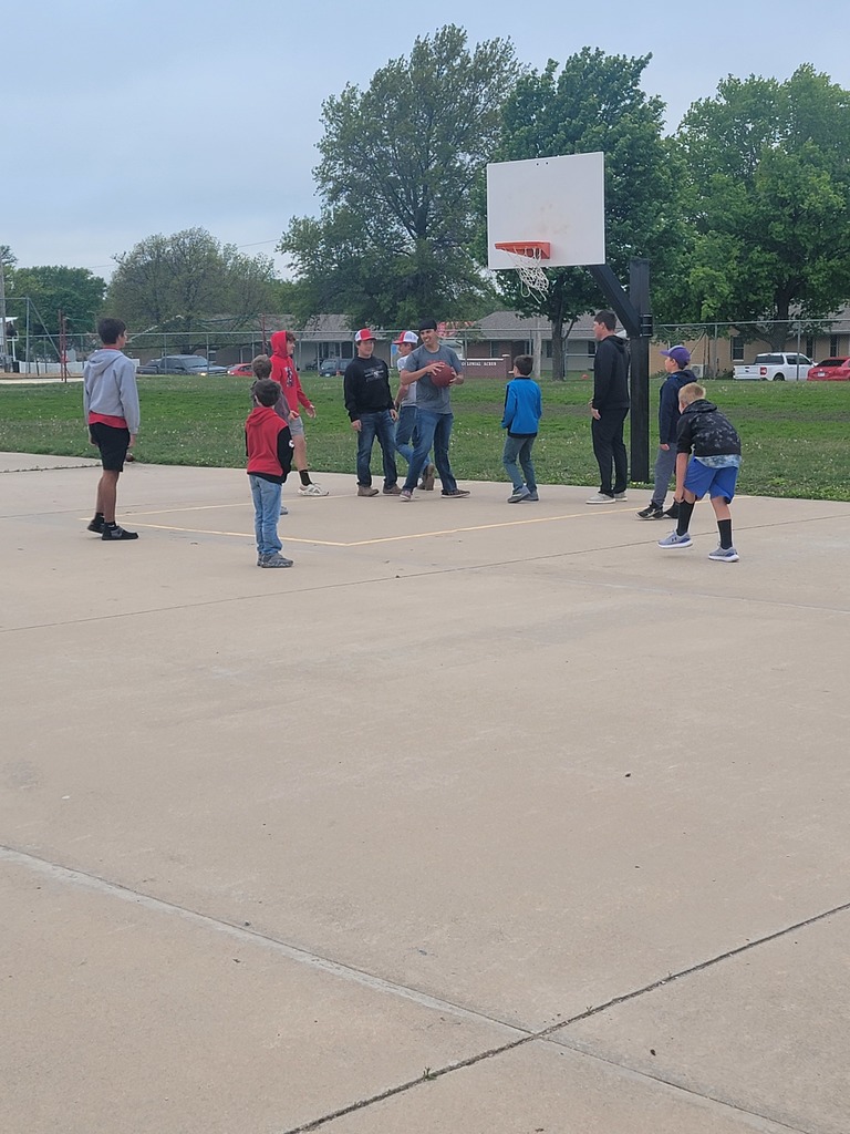 track and golf athletes greeting and playing with elementary students