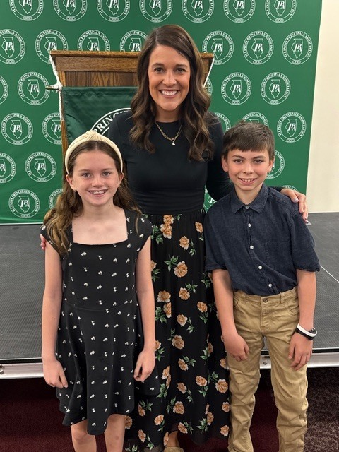 Lucie Bowman, Mrs. Arnold and Isaac Schumacher at the Illinois Principals Association Breakfast this morning.