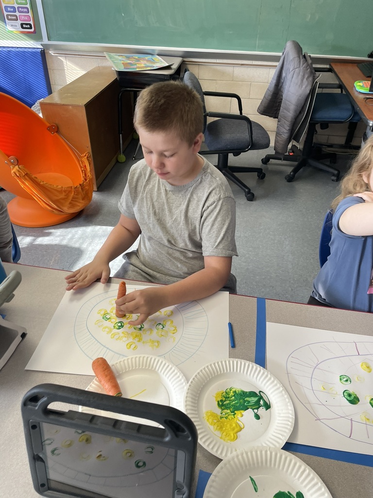 boy paints with carrot