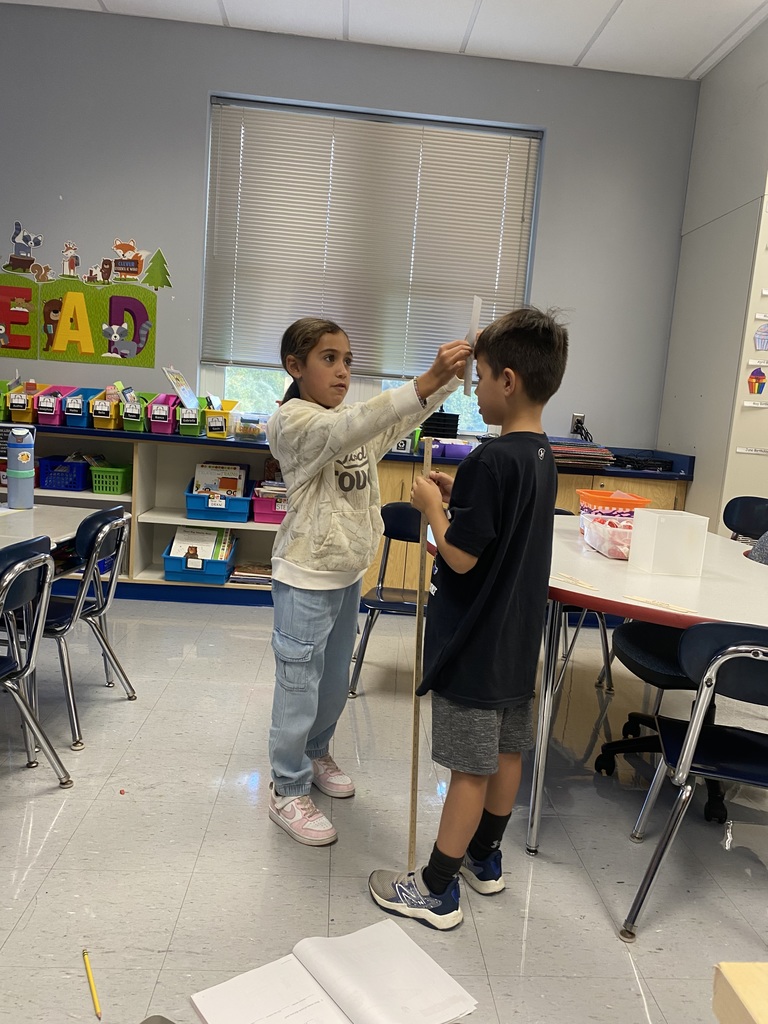 Second graders measuring each other's heights.  