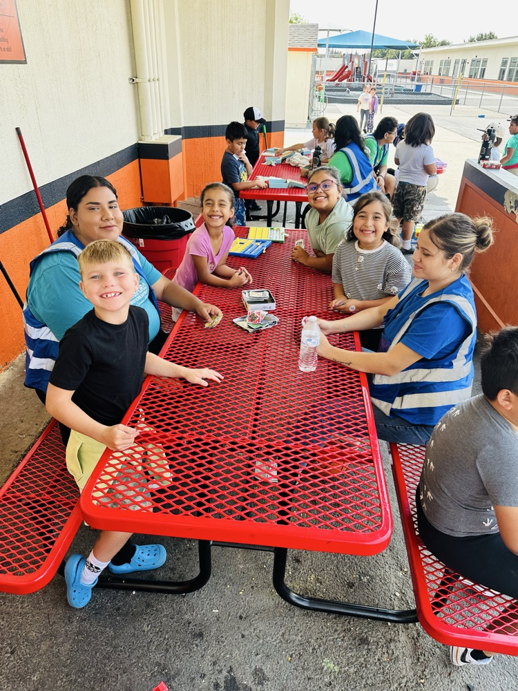 Moon Cubs playing a card game with the Stanislaus County Police Activities League  