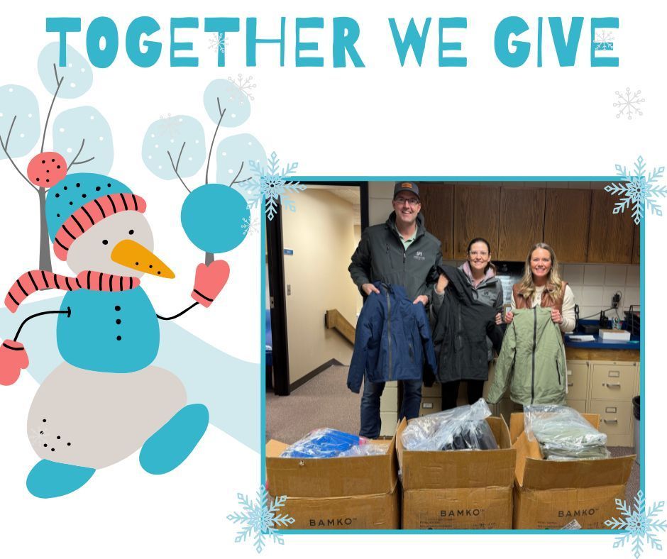 The Beutlers with MRs. Briggs holding up the new coats for Lincoln Elementary.