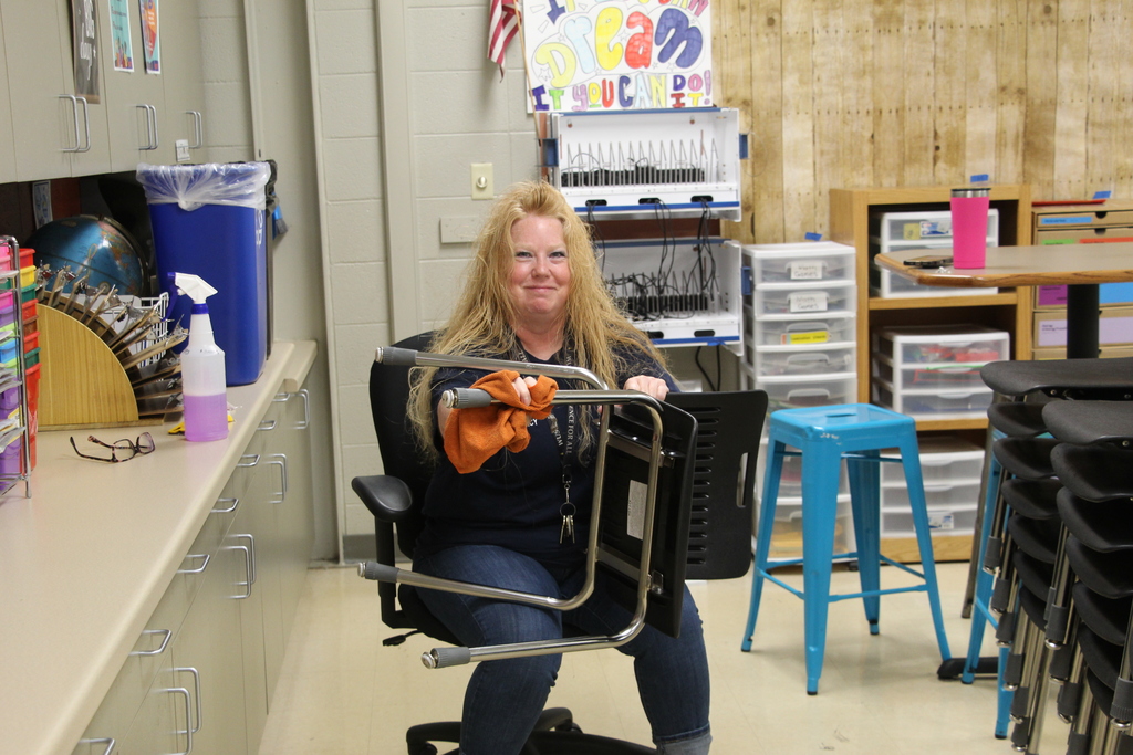 Staff deep cleaning classroom