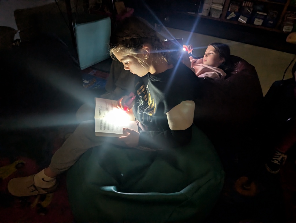 Webster students read by flashlight