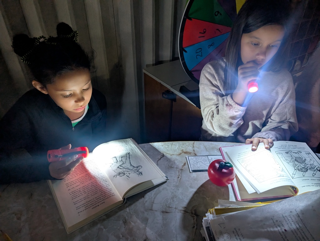 Webster students read by flashlight