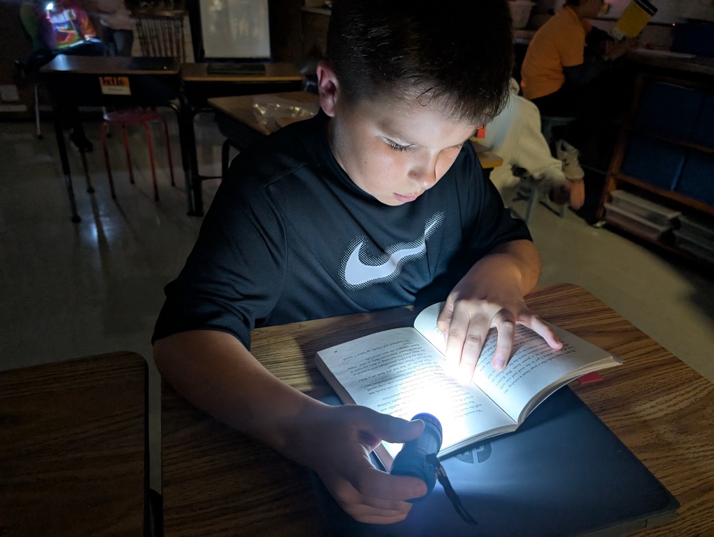 Webster students read by flashlight