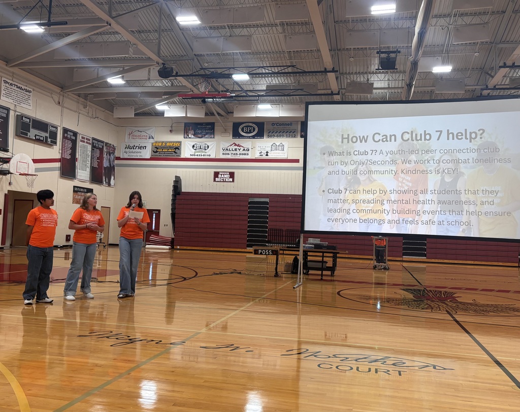 Students giving a presentation in the gym.