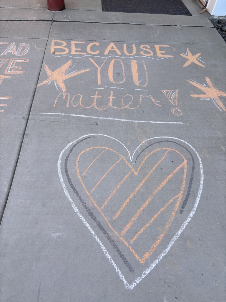 Hearts and Because You Matter on the sidewalk.