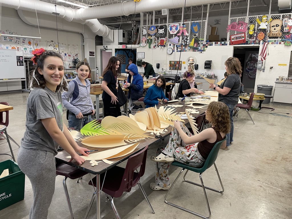 students making palm leaves out of paper and cardboard