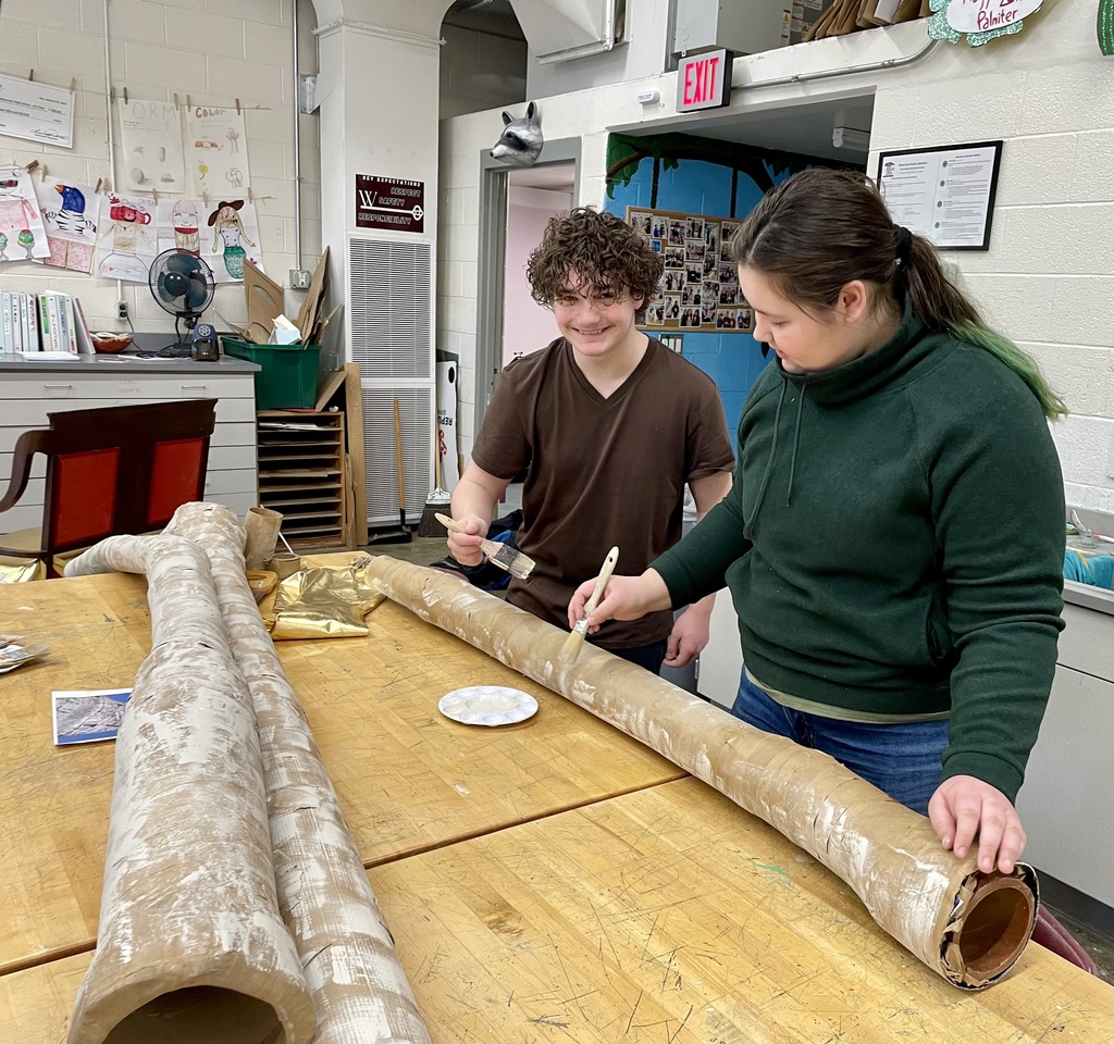 students making the tree trunks out of cardboard and paper