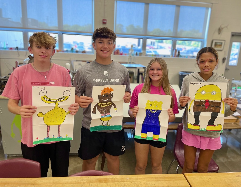 students showing their folded paper drawings