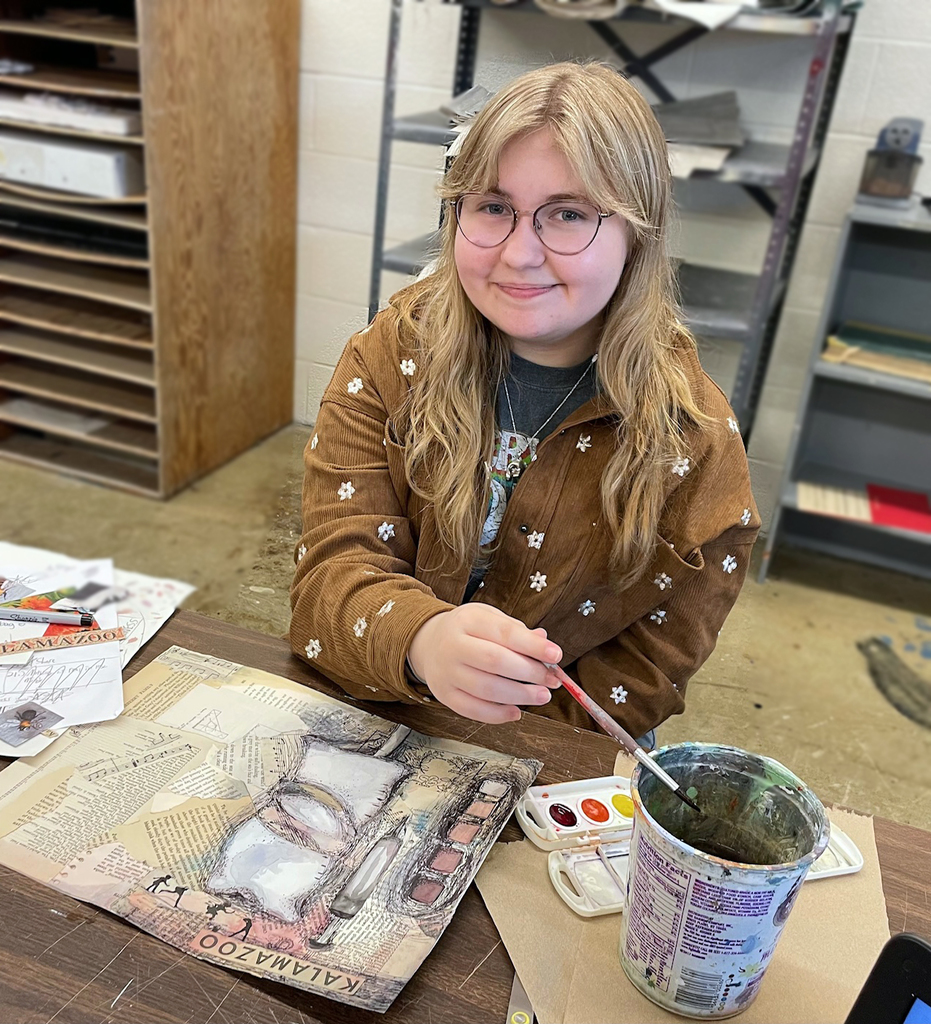 student paining her six words art piece