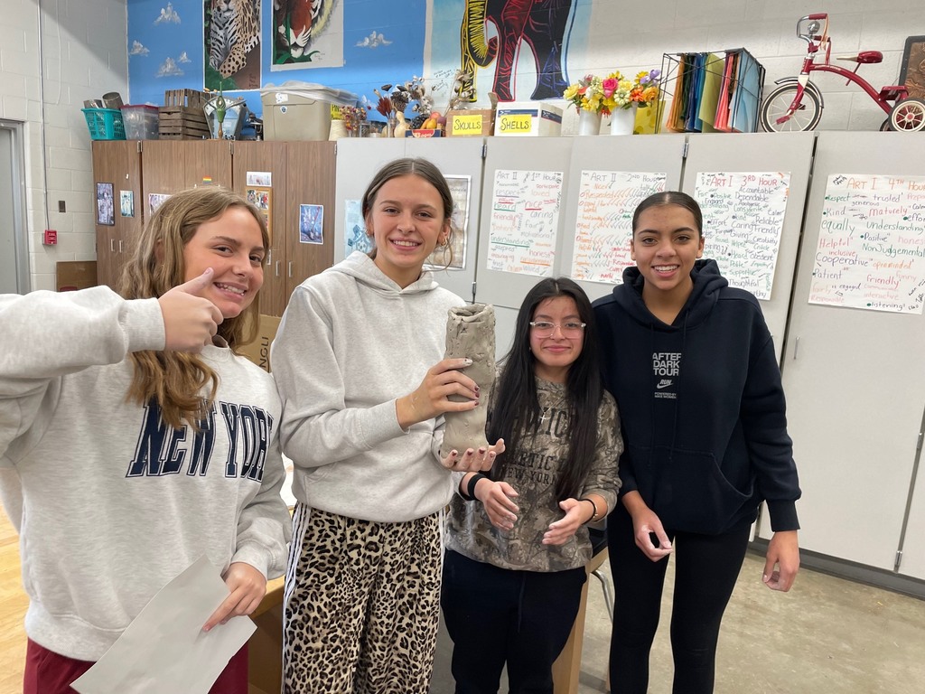 Students displaying their coil of clay