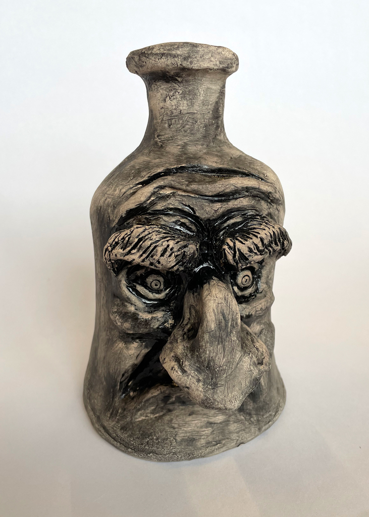 Clay Ugly Jug with a man's face on it with large nose & eyebrows