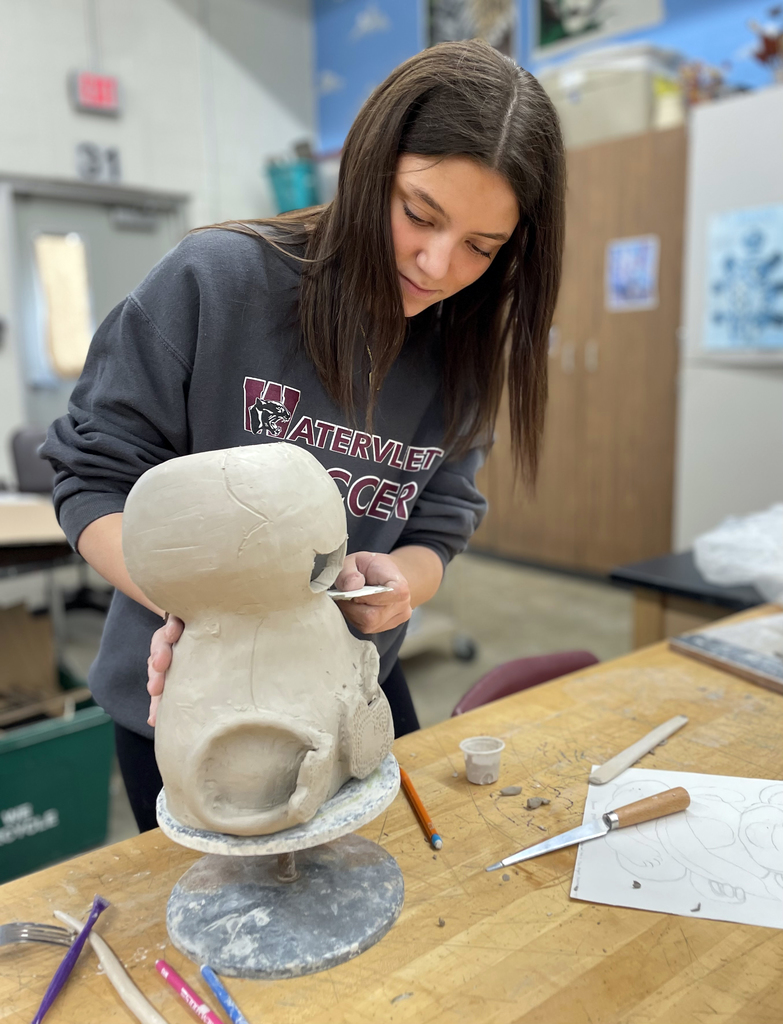 female student shaping her clay project