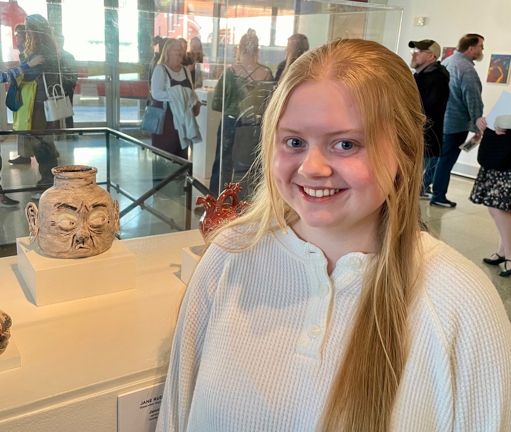 femael student next to her clay "Ugly Jug" 