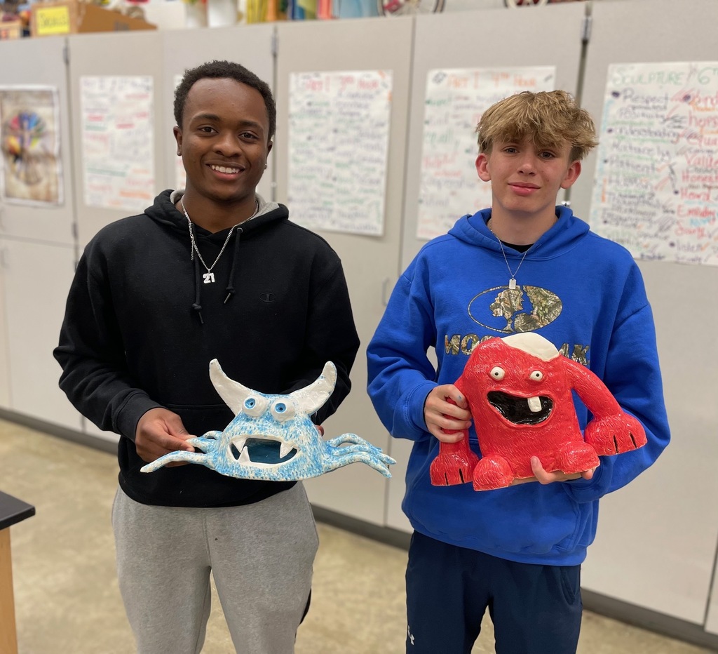 boys holding their monster projects