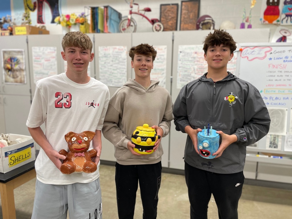 boys holding their monster projects