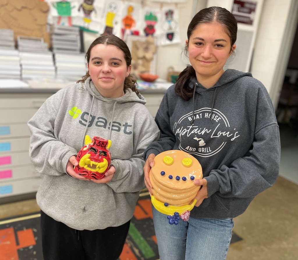 girls holding their monster projects 