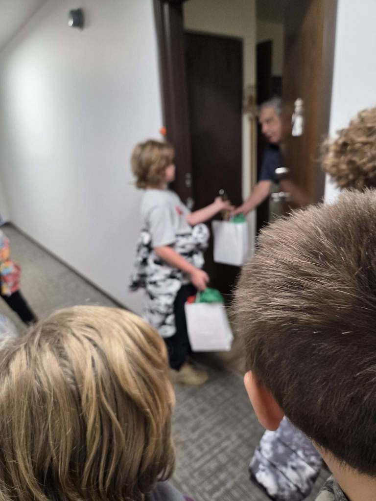 child handing gifts to a person