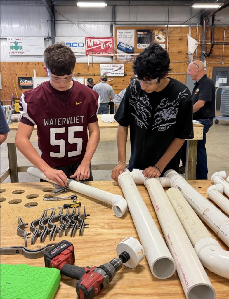 students working with pipes