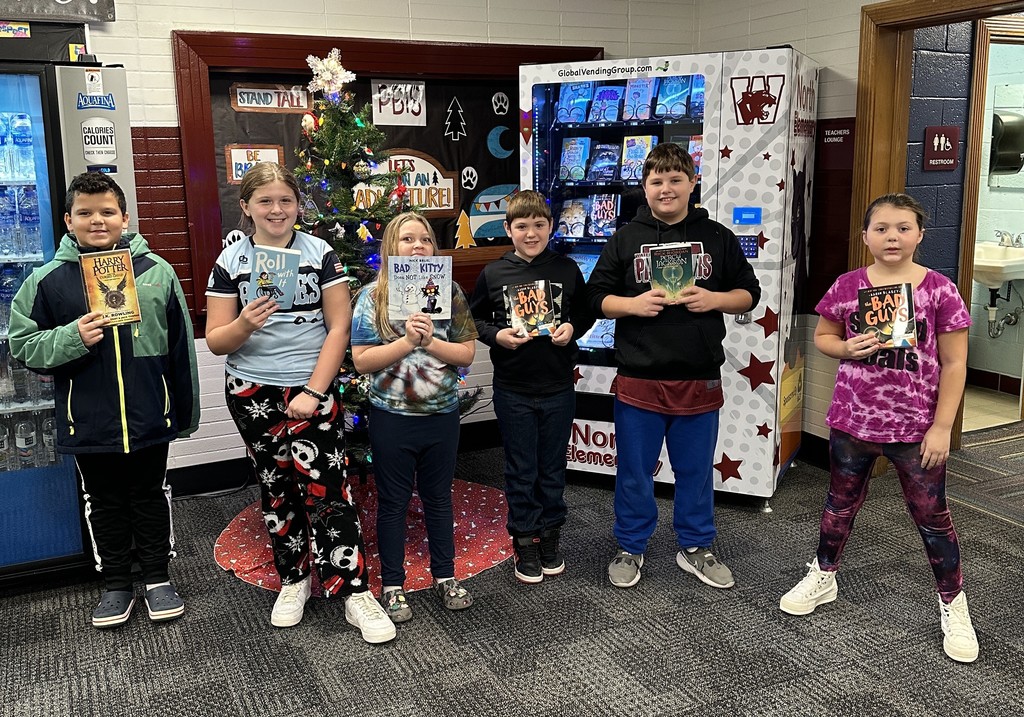 Six children, each holding up a book