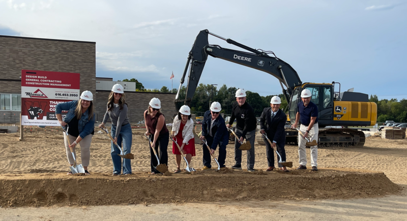 Members of school board and school admin with shovels at groundbreaking ceremoney on construction site