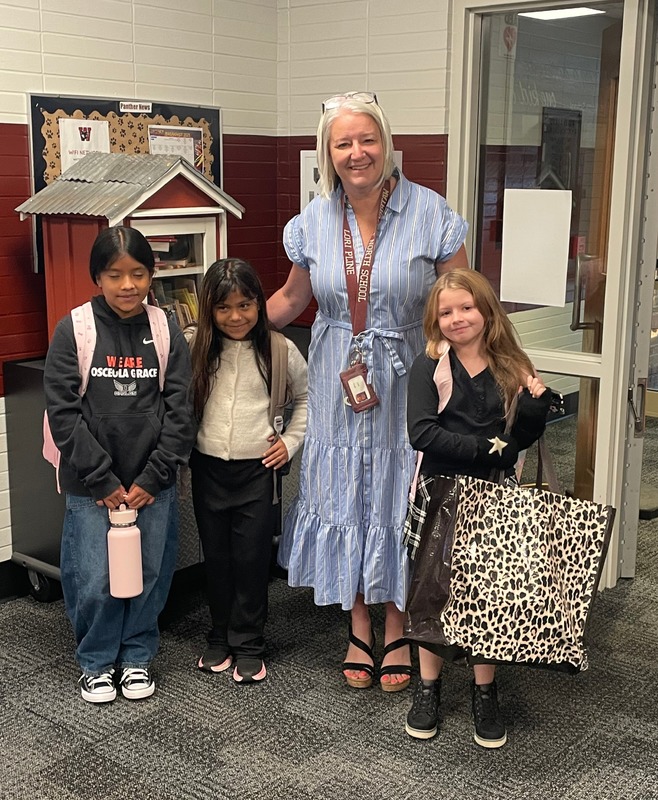 Female principal with 3 elementary age students