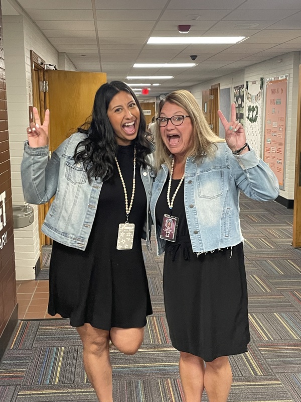 two teachers dressed alike ham it up for the camera